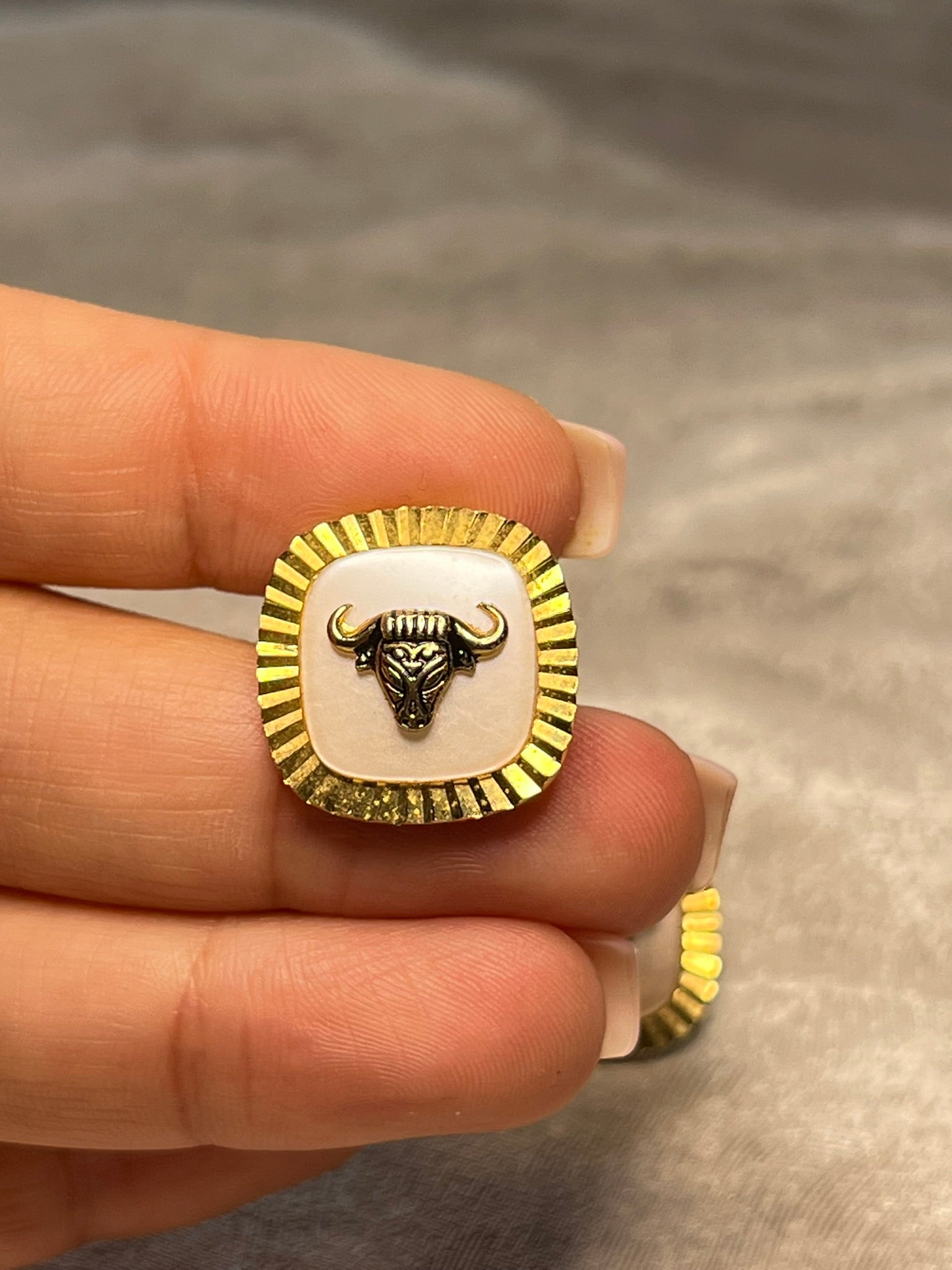 Striking vintage gold-tone cufflinks featuring a fierce bull head motif overlaid