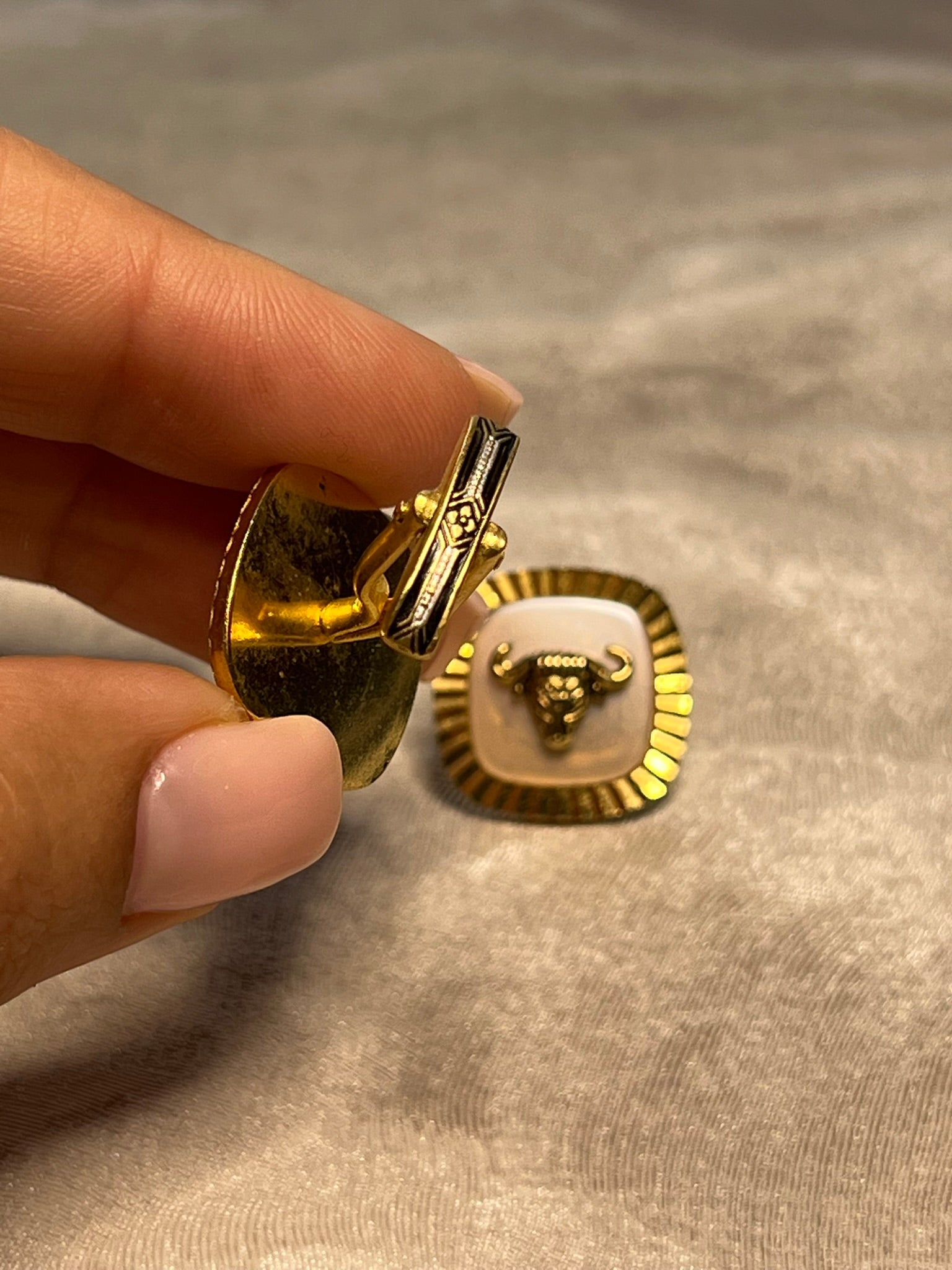 Striking vintage gold-tone cufflinks featuring a fierce bull head motif overlaid
