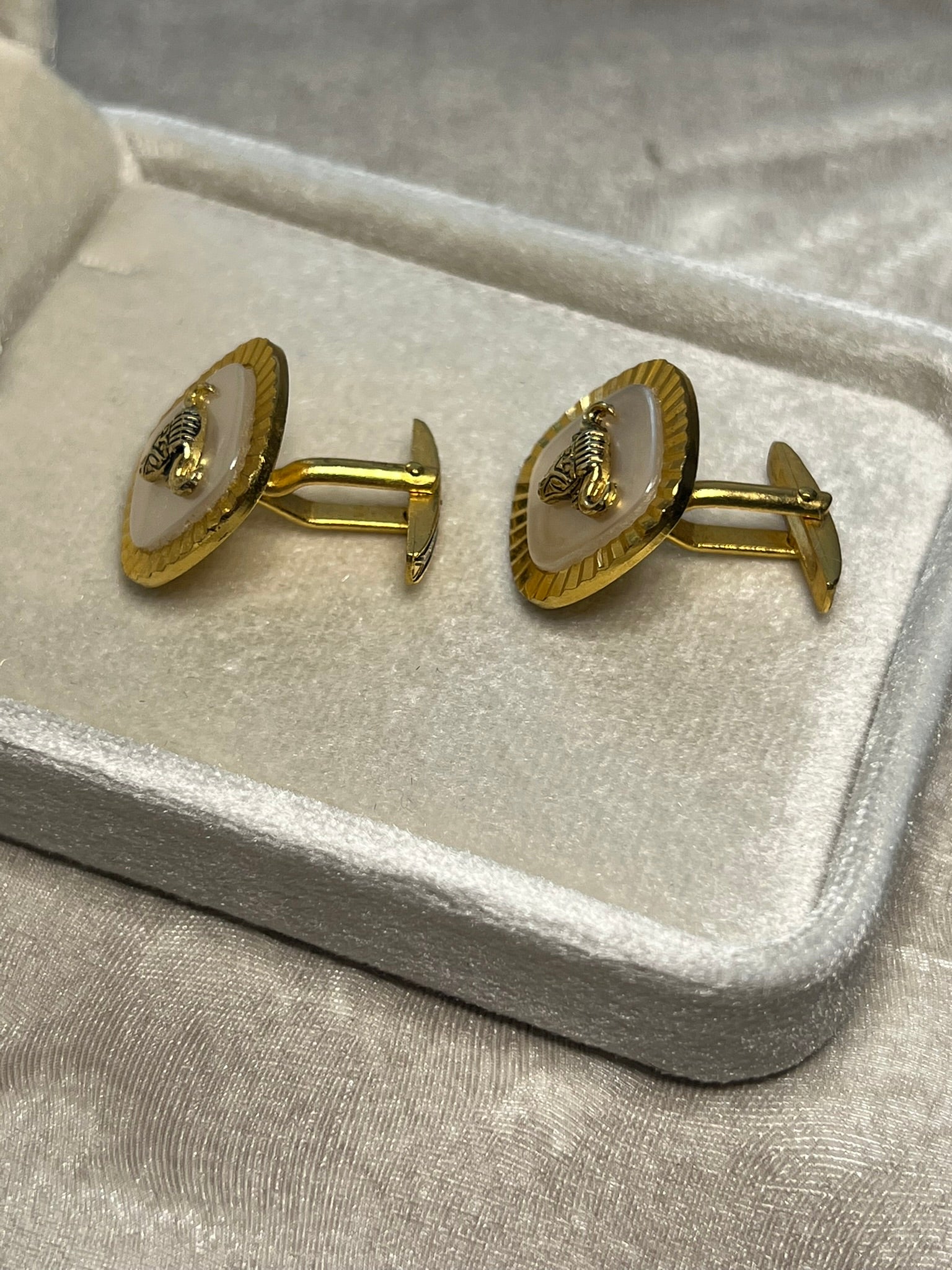 Striking vintage gold-tone cufflinks featuring a fierce bull head motif overlaid